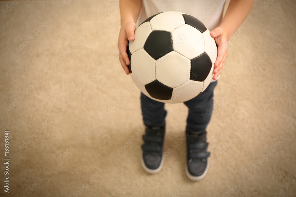 Boy holding ball for soccer football