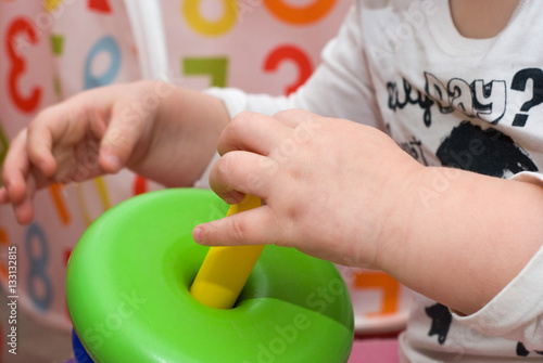 Baby's hands with pyramid toy