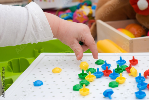 Baby's hand with mosaic toy