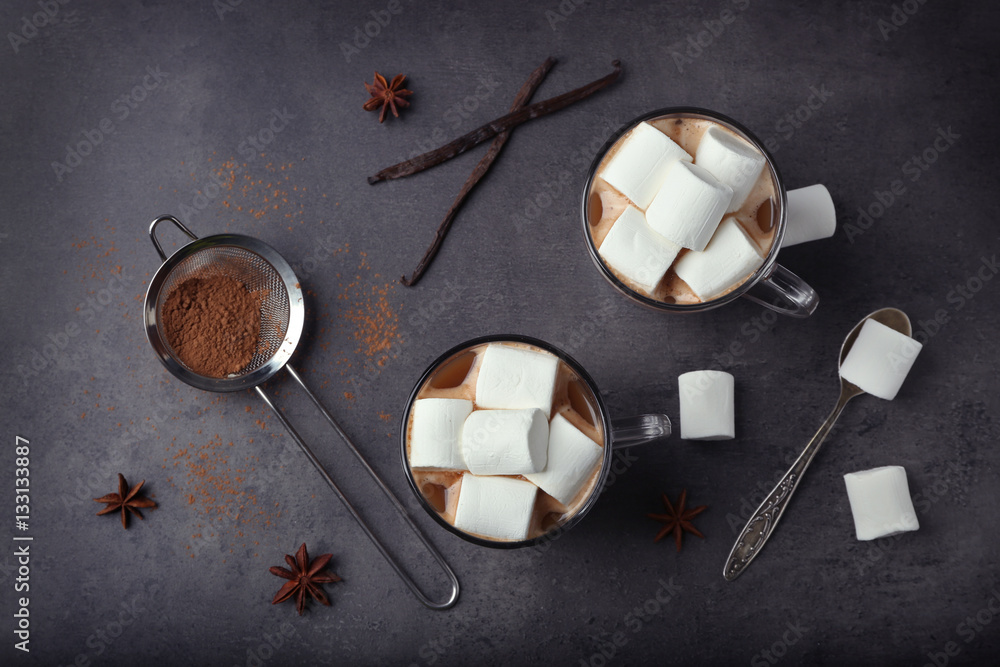 Cups of hot cocoa with marshmallows on grey background Cups of hot cocoa with marshmallows on grey background