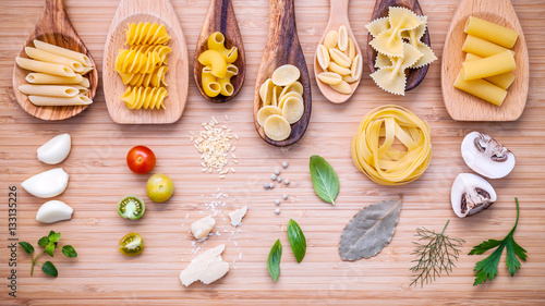 Italian food concept .Various kind of pasta in wooden spoons wit