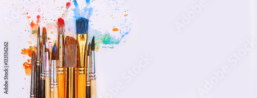 artistic brushes on wooden background photo