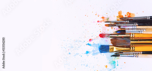 artistic brushes on wooden background photo