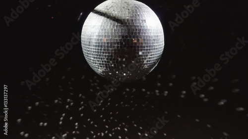 Disco mirrorball discoball spinning and reflecting light into a club venue