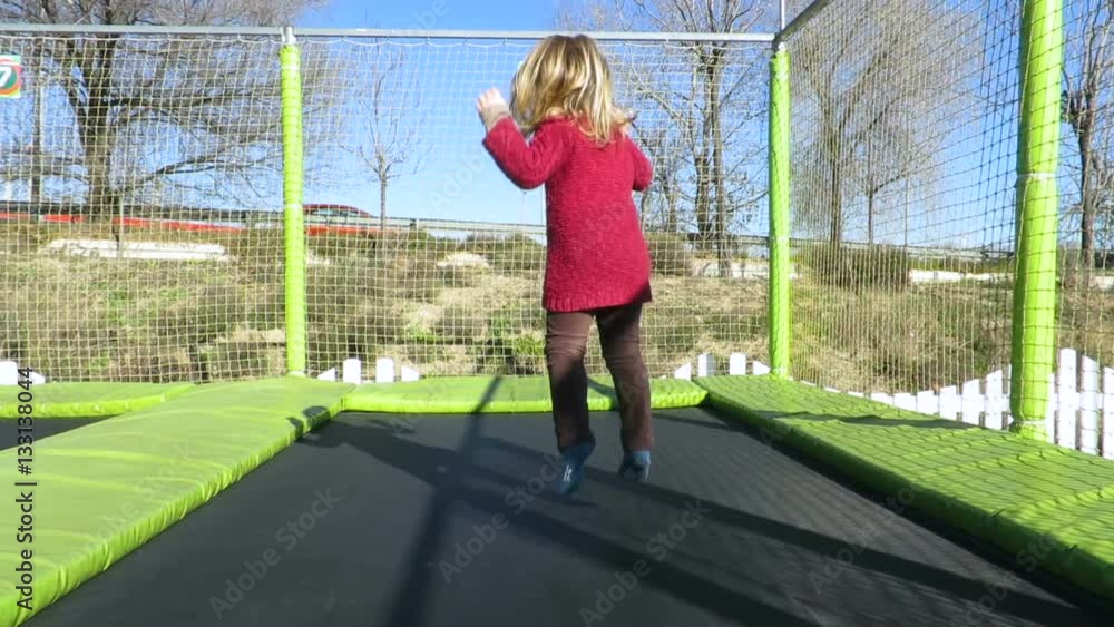 slow motion 4k video. happy three years old blonde child with winter red sweater trampolining or jumping on trampoline in outdoor playground
slow motion 4k video. happy three years old blonde child with winter red sweater trampolining or jumping on trampoline in outdoor playground