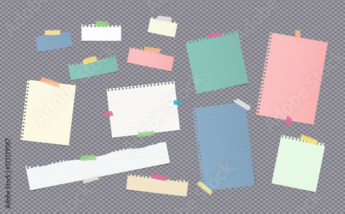 Pieces of different size colorful note, notebook, copybook paper sheets stuck with sticky tape on gray background