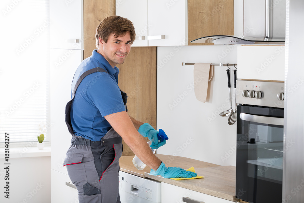 Worker In Overall Cleaning Countertop Worker In Overall Cleaning Countertop