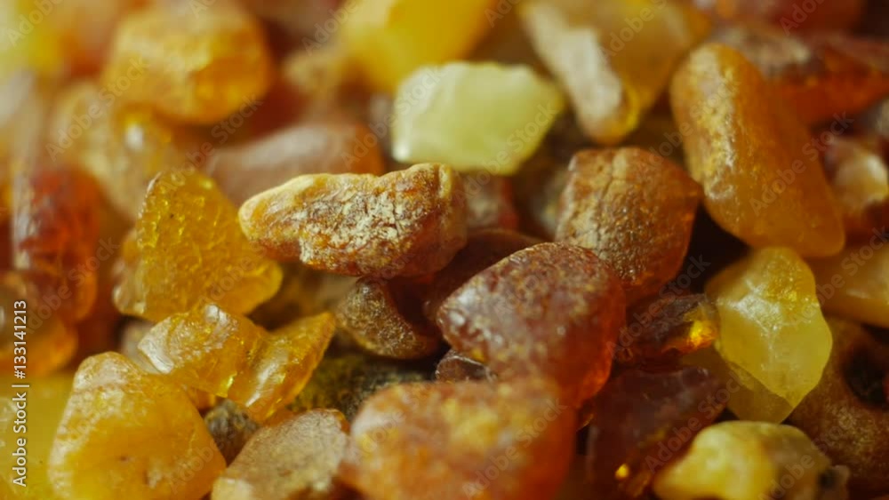Amber stones from Baltic see on turn table. Macro, slow motion video. Amber stones from Baltic see on turn table. Macro, slow motion video.