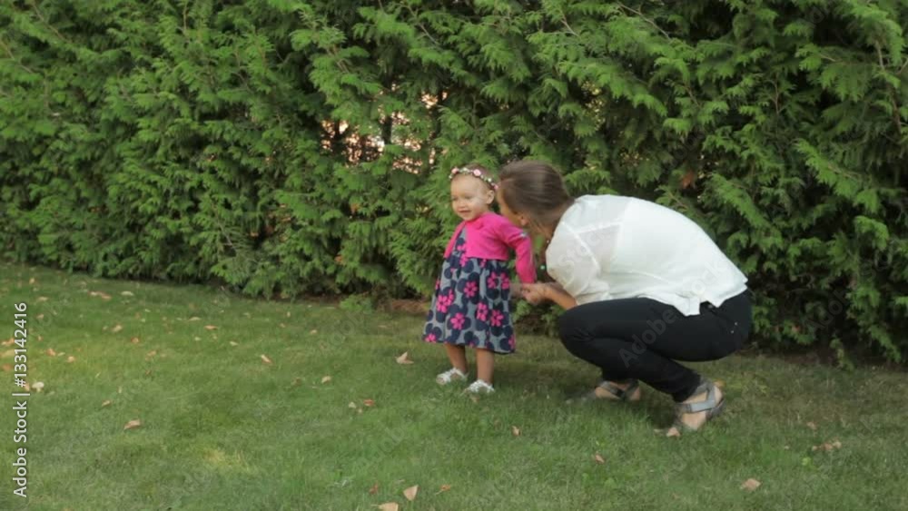 mom plays with a little girl in the Park mom plays with a little girl in the Park