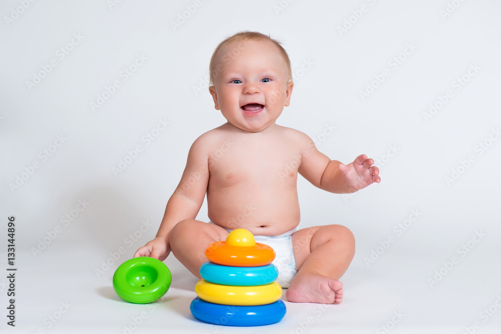 smiling child baby playing with color pyramid toy isolated. smiling child baby playing with color pyramid toy isolated.