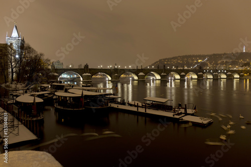 Night snowy Prague Old Town with Bridge Tower and Charles Bridge with its baroque Statues, Czech republic © Kajano
