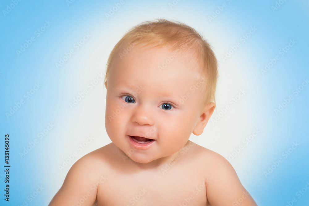 Little boy laughing. Close-up Portrait against blue background. Little boy laughing. Close-up Portrait against blue background.