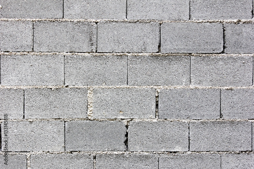 Gray concrete bricks laid in layers on top of each other - masonry