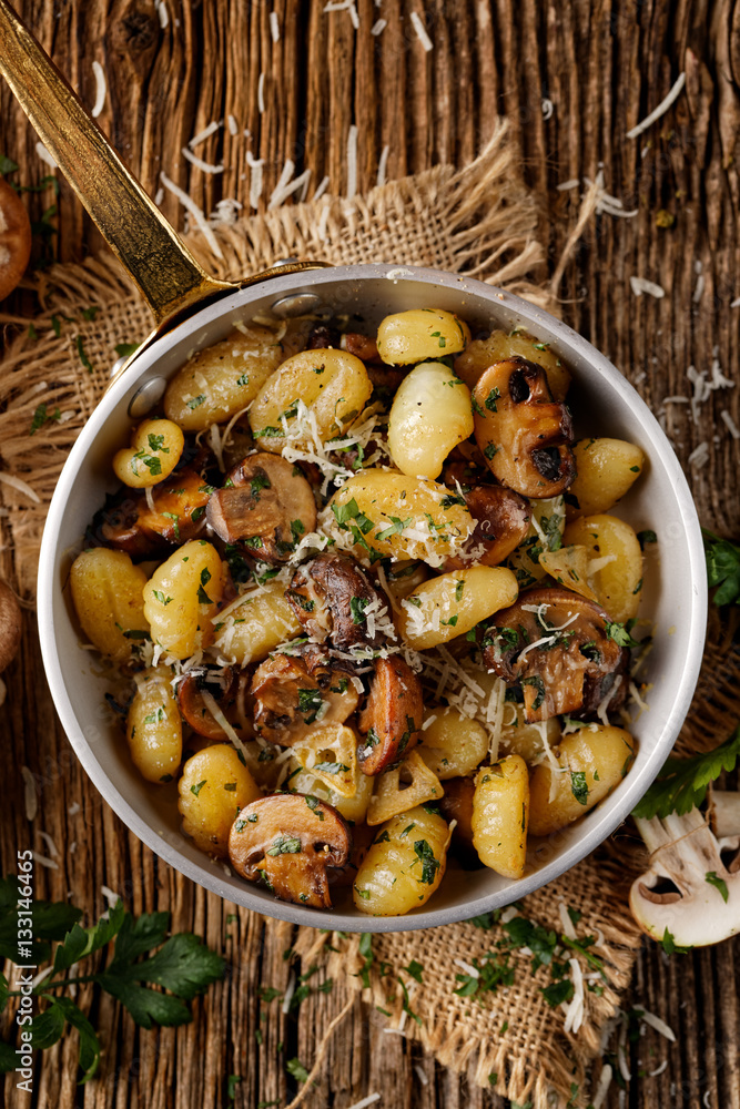 Fototapeta premium Gnocchi with brown mushrooms, top view