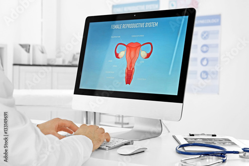 Gynecology consultation. Doctor working on computer photo