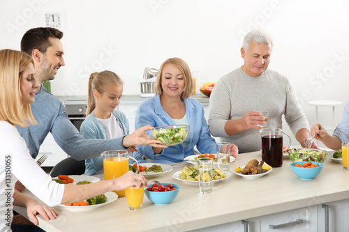 Happy family having lunch i...