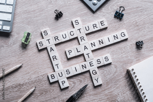 Conceptual business keywords on table with elements of game making crossword