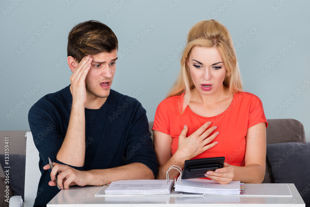 Worried Young Couple Calculating Their Bills Worried Young Couple Calculating Their Bills