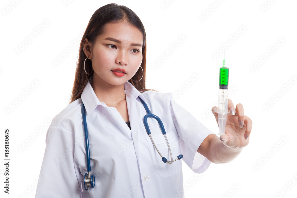 Young Asian female doctor smile hold syringe focus at syringe. Young Asian female doctor smile hold syringe focus at syringe.