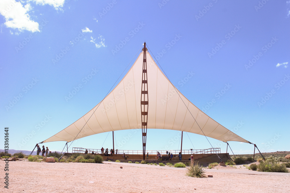 Obraz premium white events tent in a sand field on a sunny summer's day