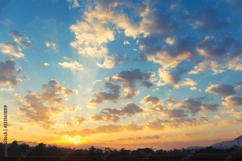 Dramatic sky include cloud, sunset or sunrise, outdoor space and horizon or skyline. Colorful with yellow, orange and blue color at evening in autumn. For scene, backdrop, background and wallpaper. Dramatic sky include cloud, sunset or sunrise, outdoor space and horizon or skyline. Colorful with yellow, orange and blue color at evening in autumn. For scene, backdrop, background and wallpaper.