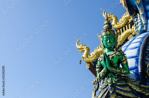 Wallpaper Mural Thai Tradition Green Male Angel Sawasdee (Hello) with Blue Sky at Wat Rong Sua Ten Chiang Rai Thailand.  Most Visited from Tourist. Torontodigital.ca