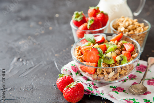 muesli with fruit in a bowl on a table, selective focus, copy space