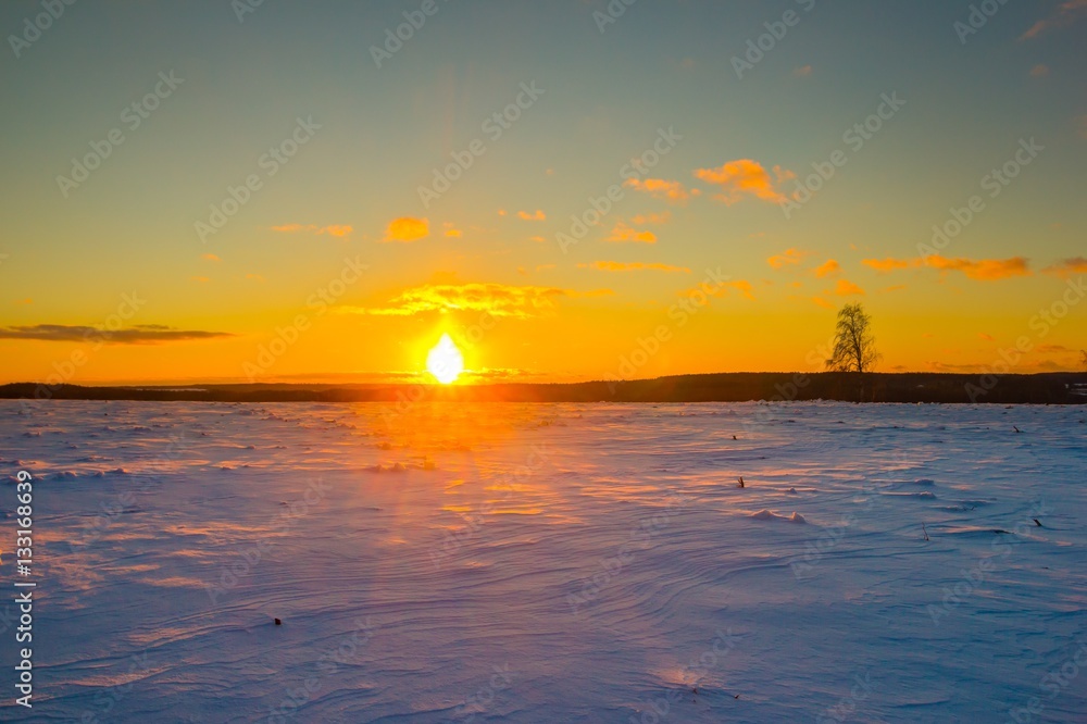 Sunset over winter snow fields