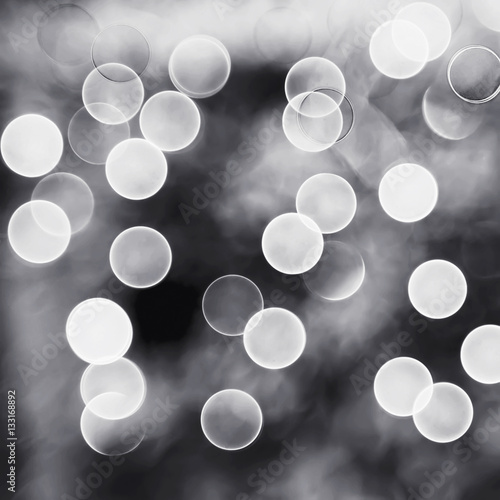 Bokeh night light, abstract background in monochrome.