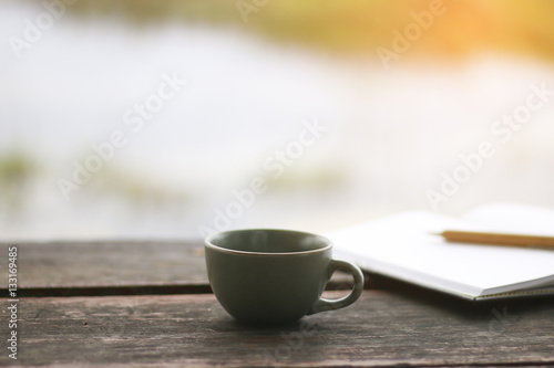 Stock Photo:.A cup of coffee on the wood table