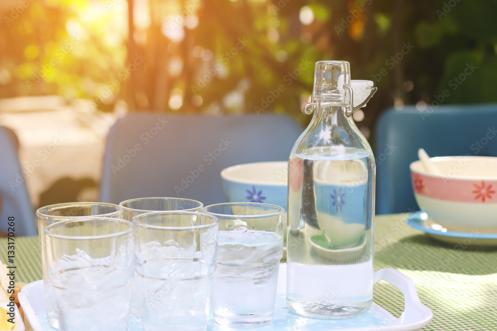 Stock Photo:.Glass of water with a bottle on table Stock Photo:.Glass of water with a bottle on table