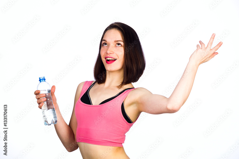 Young woman in sportswear with a bottle of drinking water Young woman in sportswear with a bottle of drinking water