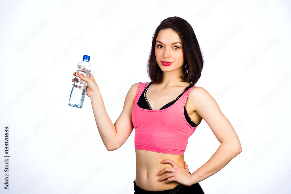 Young woman in sportswear with a bottle of drinking water Young woman in sportswear with a bottle of drinking water