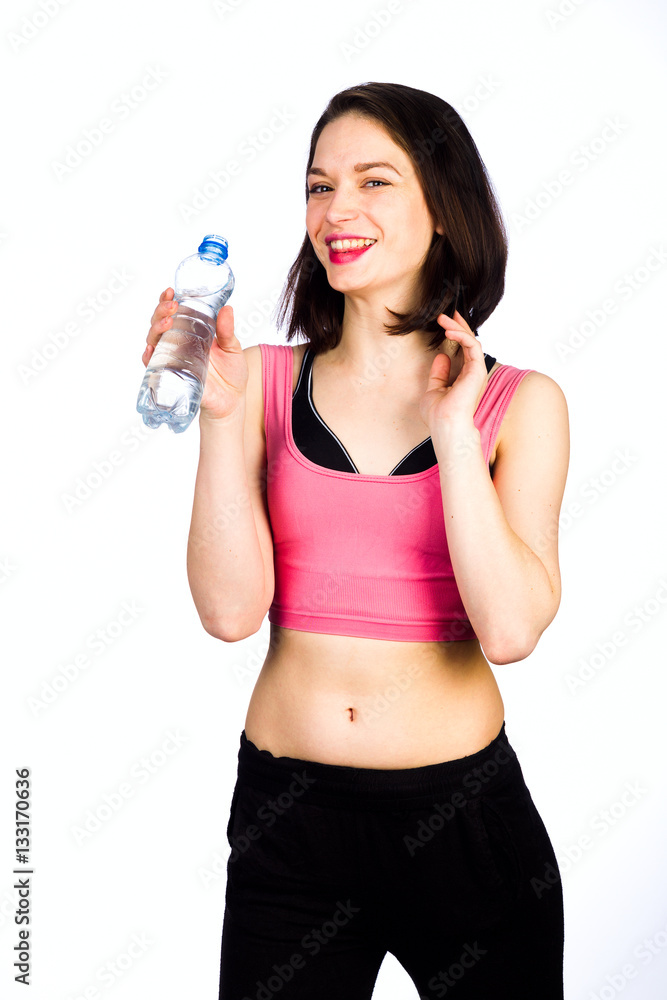Young woman in sportswear with a bottle of drinking water Young woman in sportswear with a bottle of drinking water