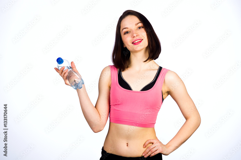 Young woman in sportswear with a bottle of drinking water Young woman in sportswear with a bottle of drinking water
