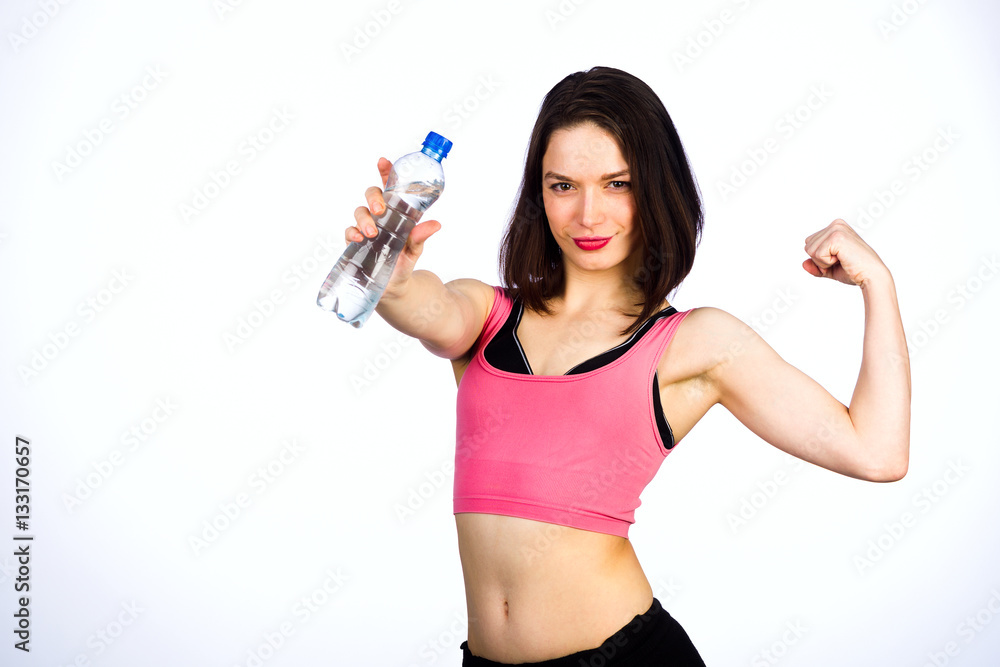 Young woman in sportswear with a bottle of drinking water Young woman in sportswear with a bottle of drinking water