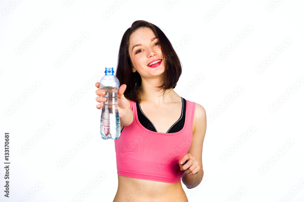 Young woman in sportswear with a bottle of drinking water Young woman in sportswear with a bottle of drinking water