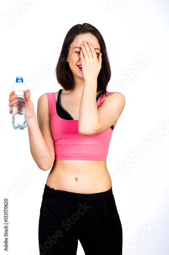 Young woman in sportswear with a bottle of drinking water