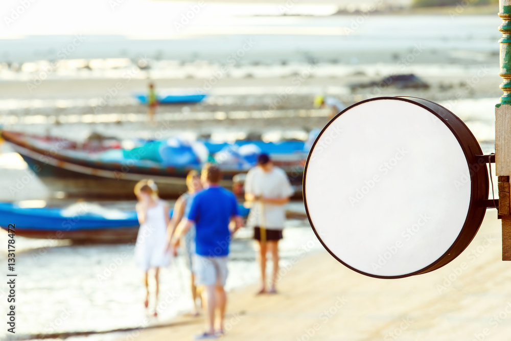 Fototapeta premium Mockup of beach restaurant round sign at asian seashore backgrou