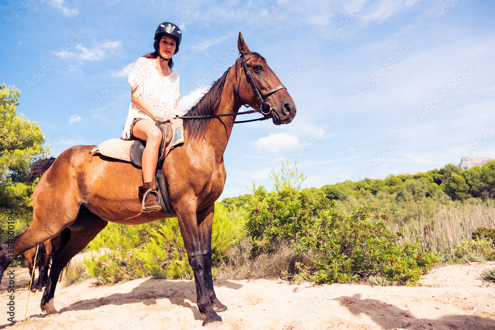 Obraz premium Young Woman Horseback Riding