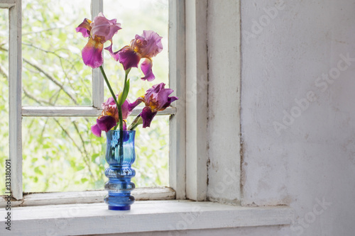 Fototapeta Naklejka Na Ścianę i Meble -  Flower in blue  vase on windowsill