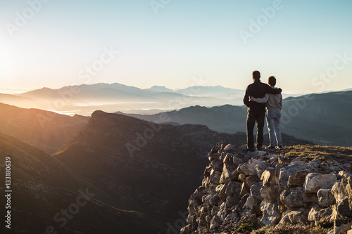 Father and son hiking on high mountain