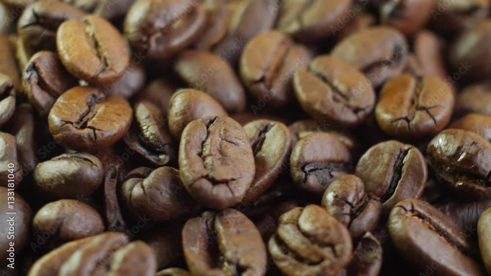 Close up of coffee beans. Loopable rotation. In front of the camera rotates plate with coffee beans Close up of coffee beans. Loopable rotation. In front of the camera rotates plate with coffee beans