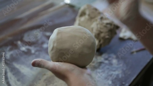Potter works with clay. Making pots and other products
