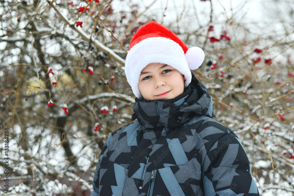 Teen boy in cap Santa Claus outdoor Teen boy in cap Santa Claus outdoor