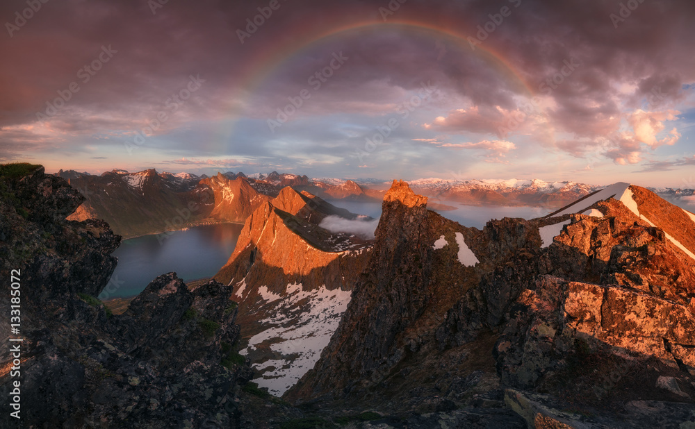 Norway. The island of Senja. Rainbow over a fjord Steinfjorden