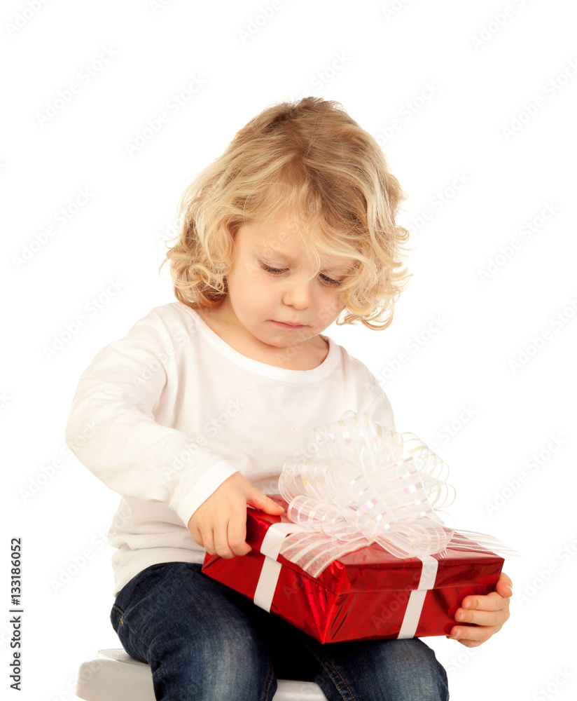 Small blond child with a red present Small blond child with a red present