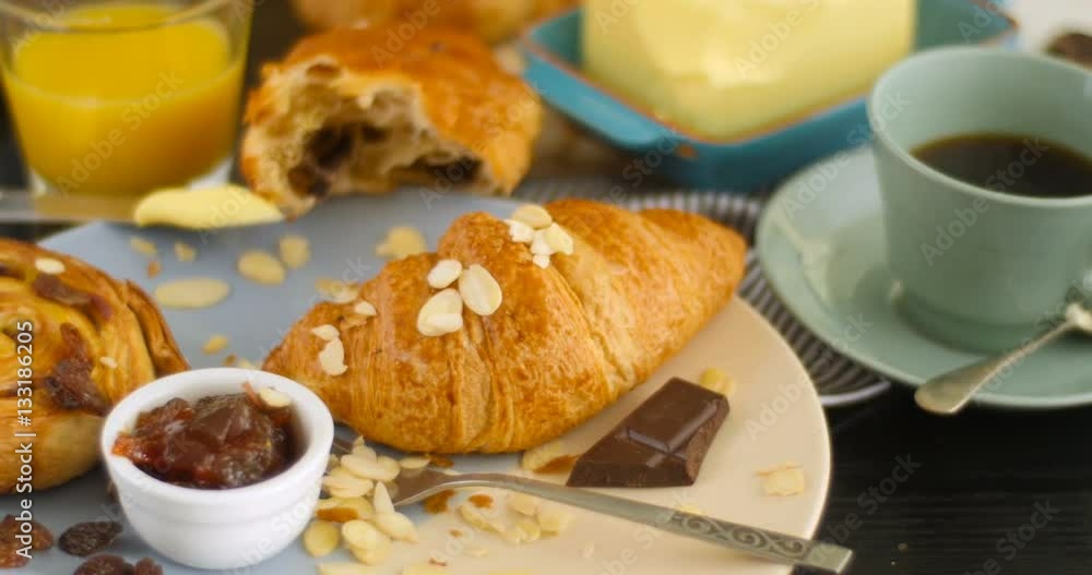 Dolly close up view of a French breakfast with pastries, orange juice and coffee Dolly close up view of a French breakfast with pastries, orange juice and coffee