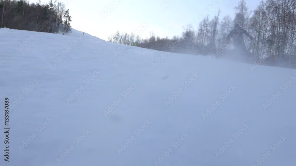 Skier and snowboarder skiing slope on sunny winter day Skier and snowboarder skiing slope on sunny winter day