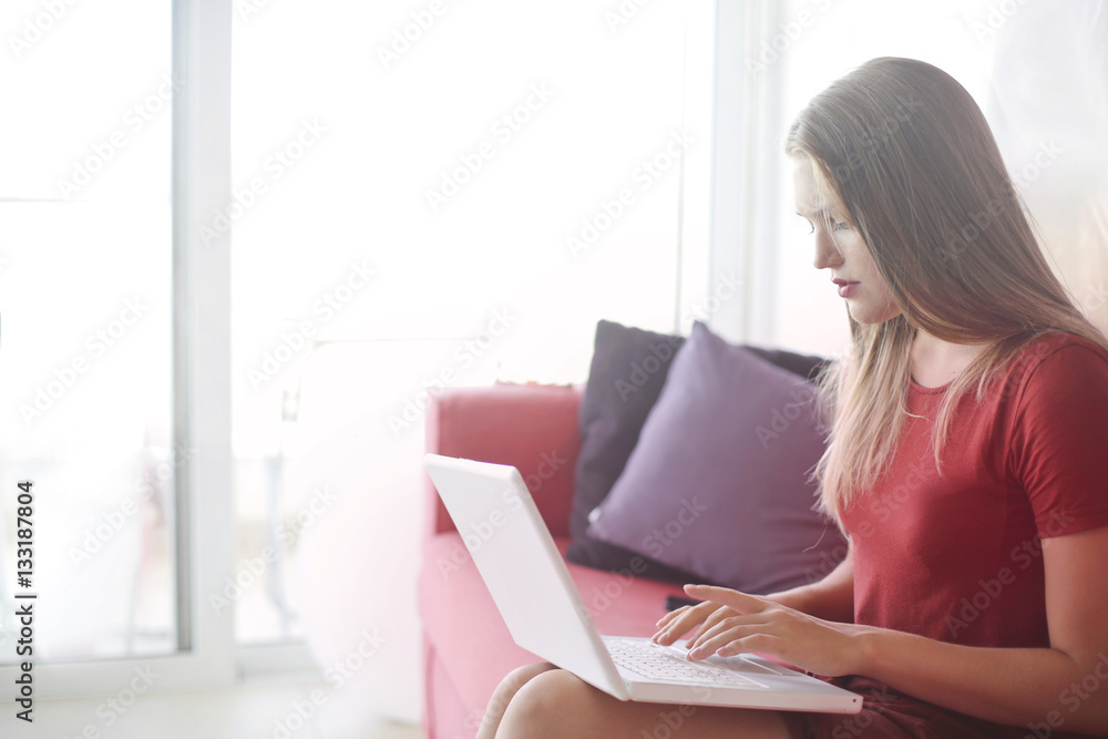 Fototapeta premium Using laptop in red